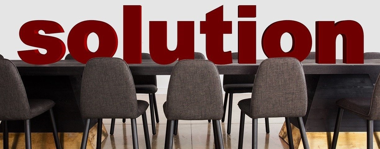 picture of the word solution on top of a conference table